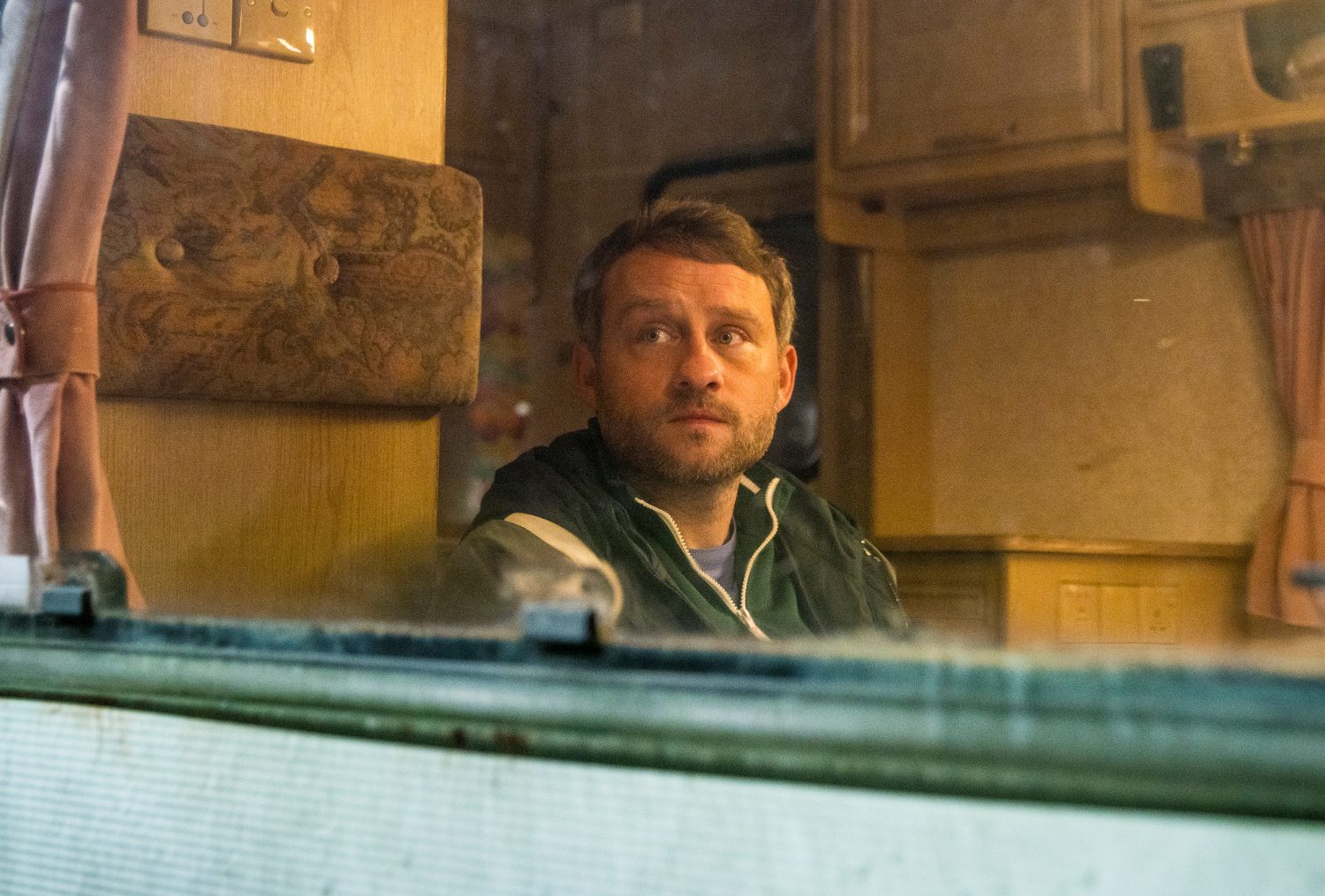 Coronation Street tonight: Paul looks out of the window of the motorhome sadly