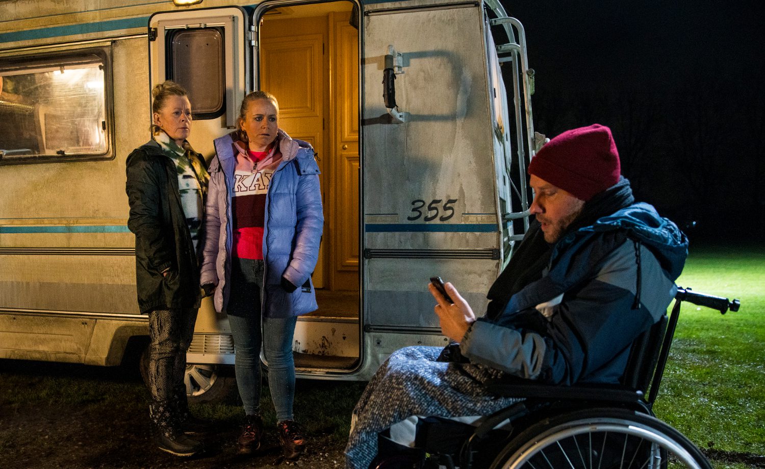 Bernie and Gemma in Corrie glare at Paul worriedly as he looks at his phone in the middle of a field
