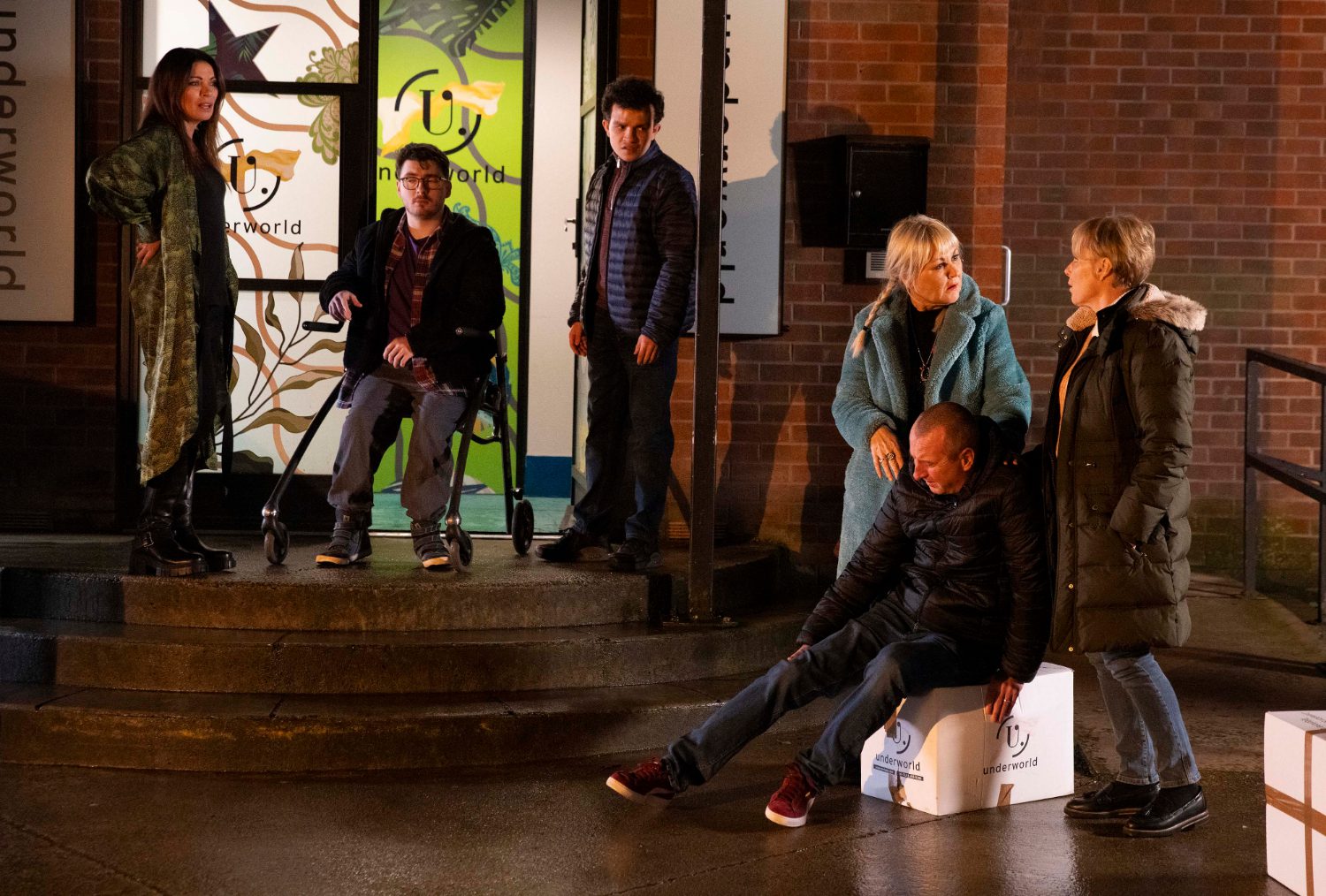 Coronation Street's Carla, Bobby, Simon, Beth, Kirk and Sally are outside of the factory dealing with Kirk's sprained ankle