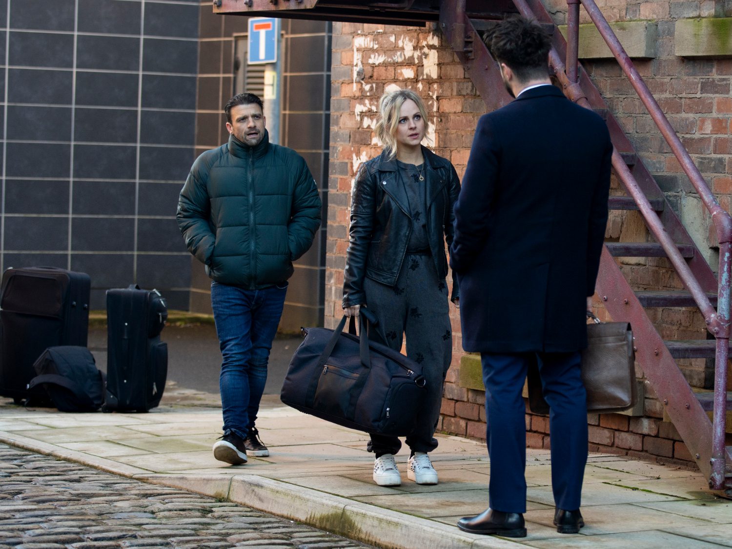 Damon Hay and Sarah Barlow talk to Adam Barlow looking wary