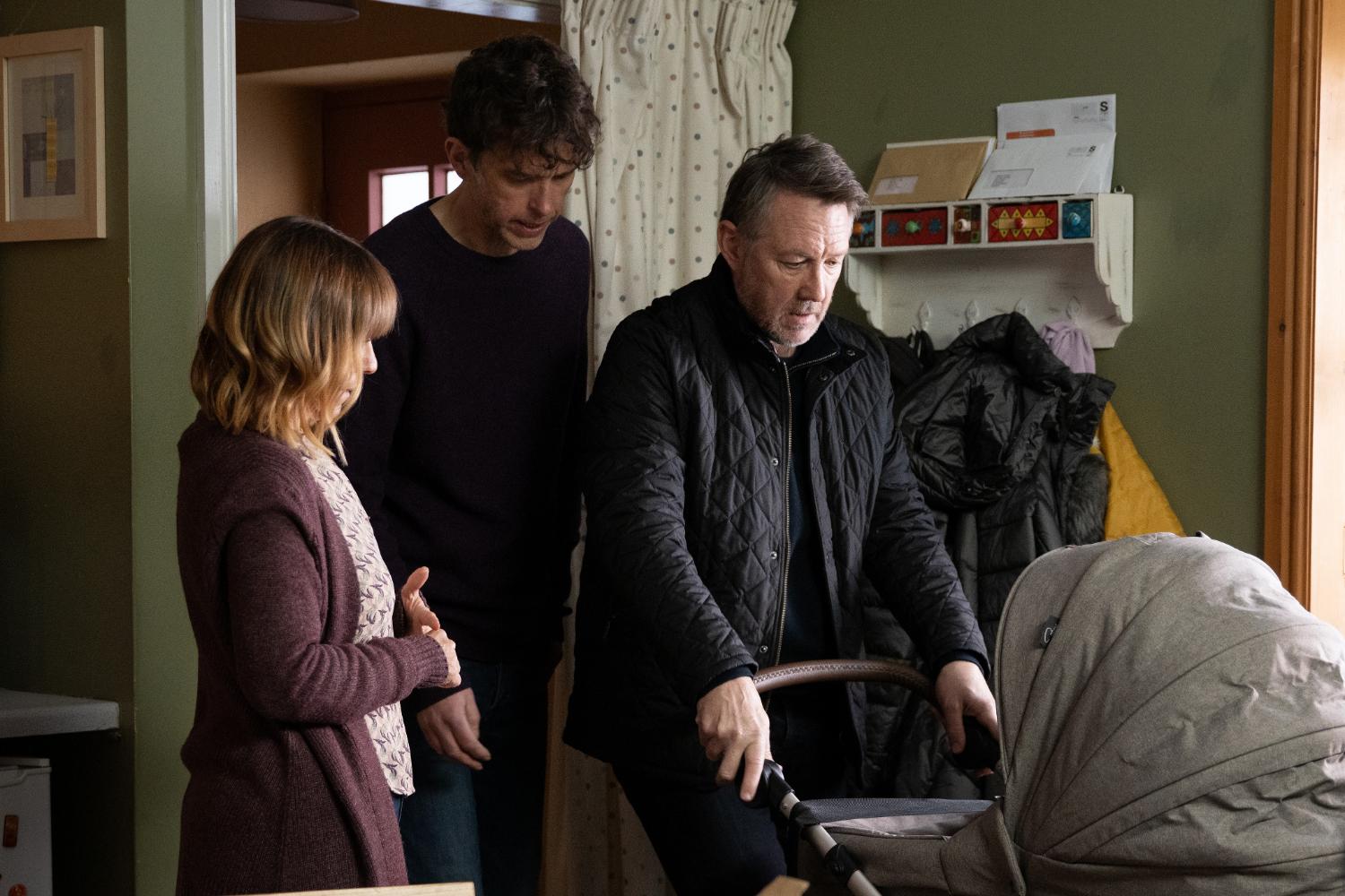 Emmerdale's Rhona and Marlon are staring at Gus with the pram