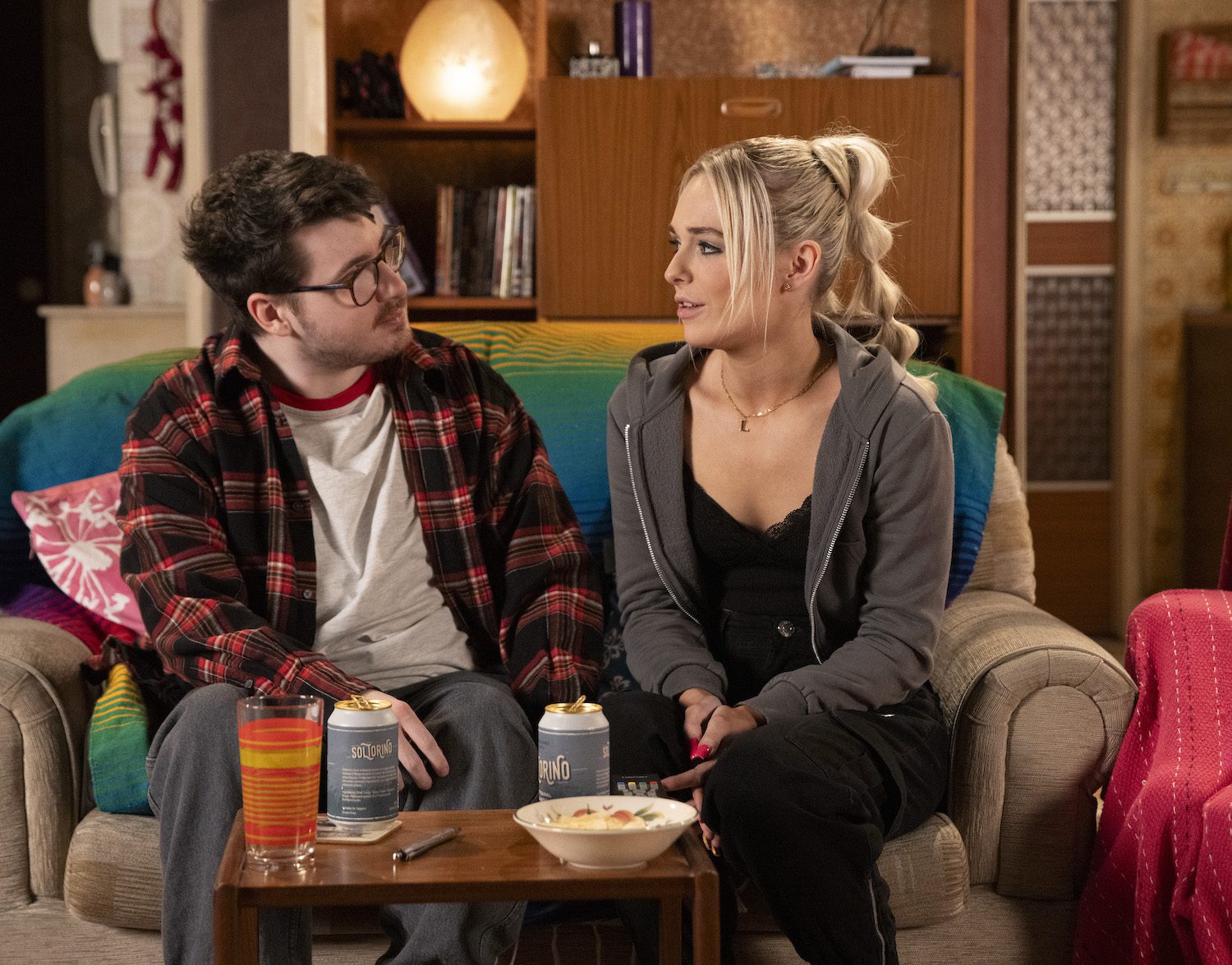 Coronation Street's Bobby and Lauren are sitting on the sofa in the flat