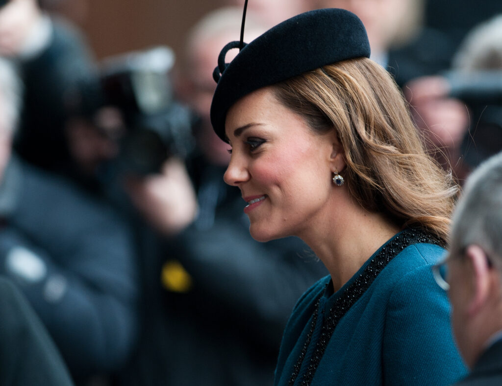 Kate Middleton wears a teal dress and black hat