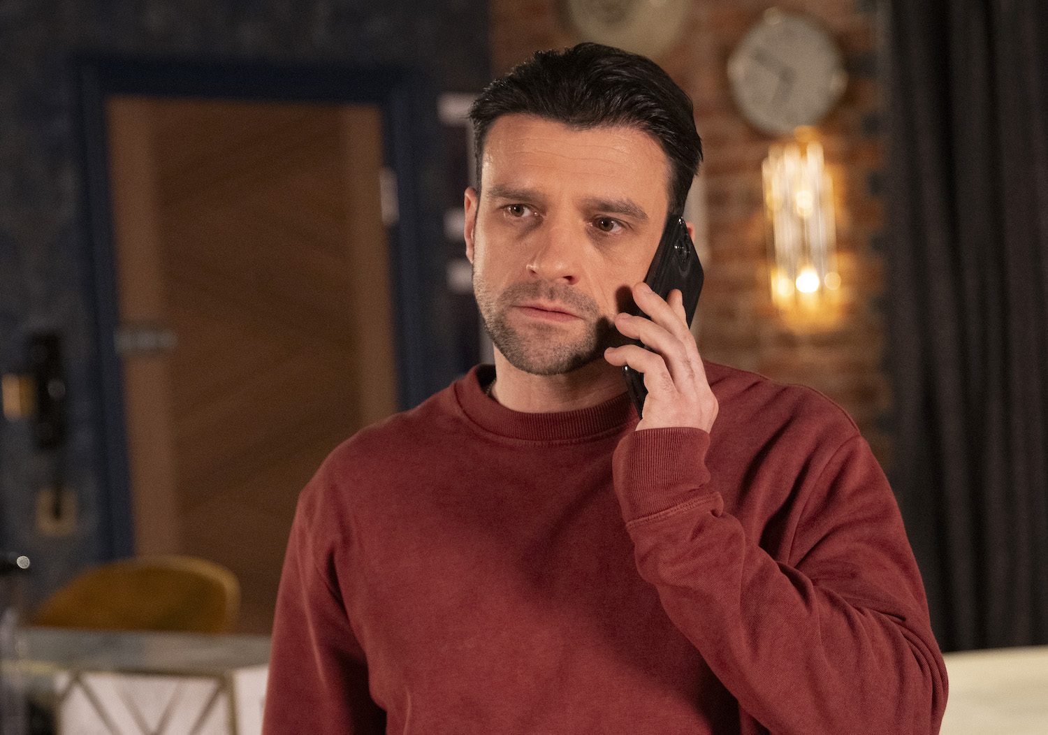 Damon Hay looks stressed as he makes a phone call