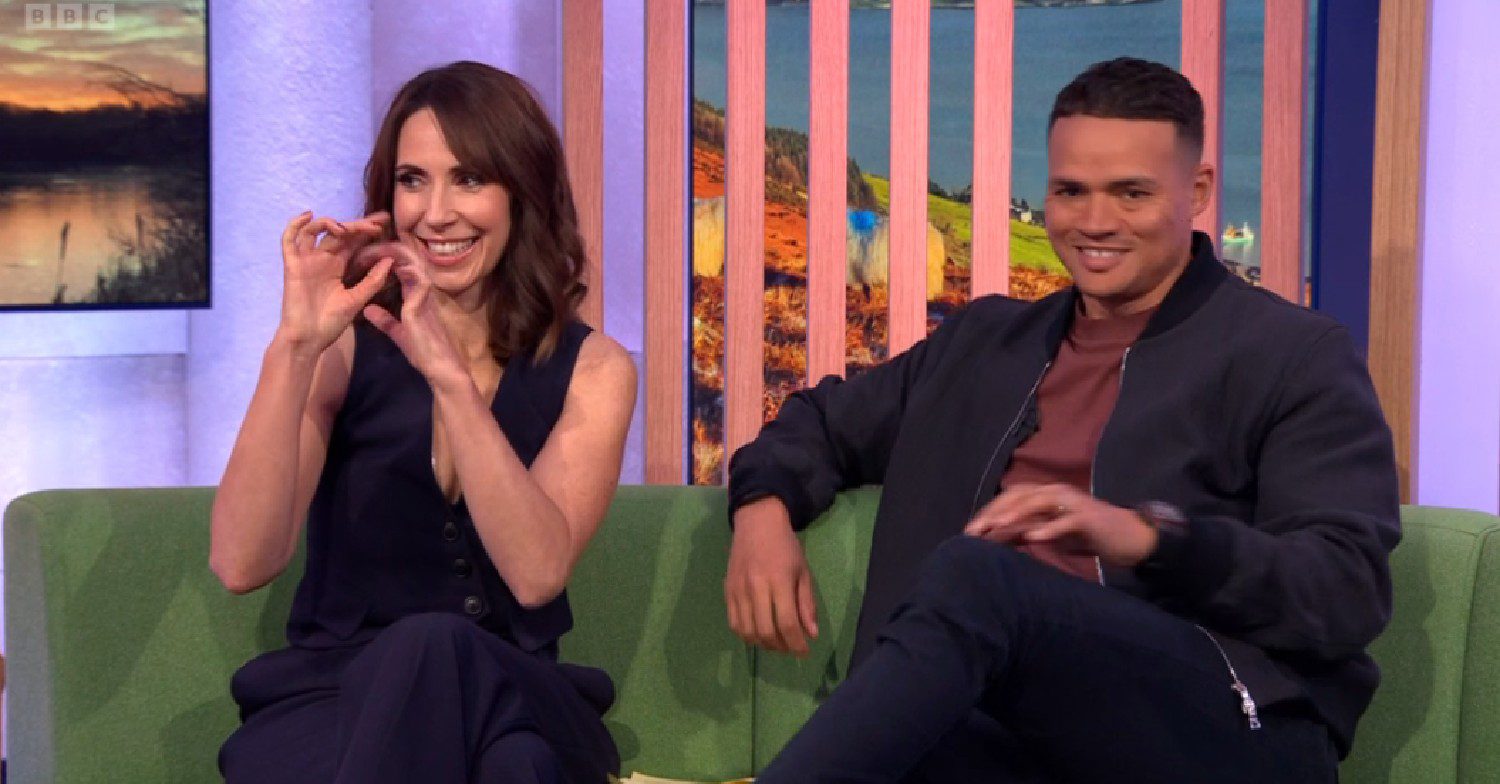 Alex Jones gestures a trumpet as Jermaine Jenas smiles on The One Show