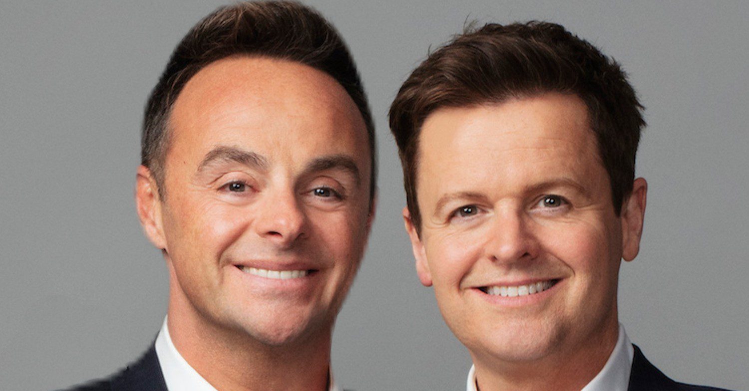 Ant and Dec wearing suits against a grey background