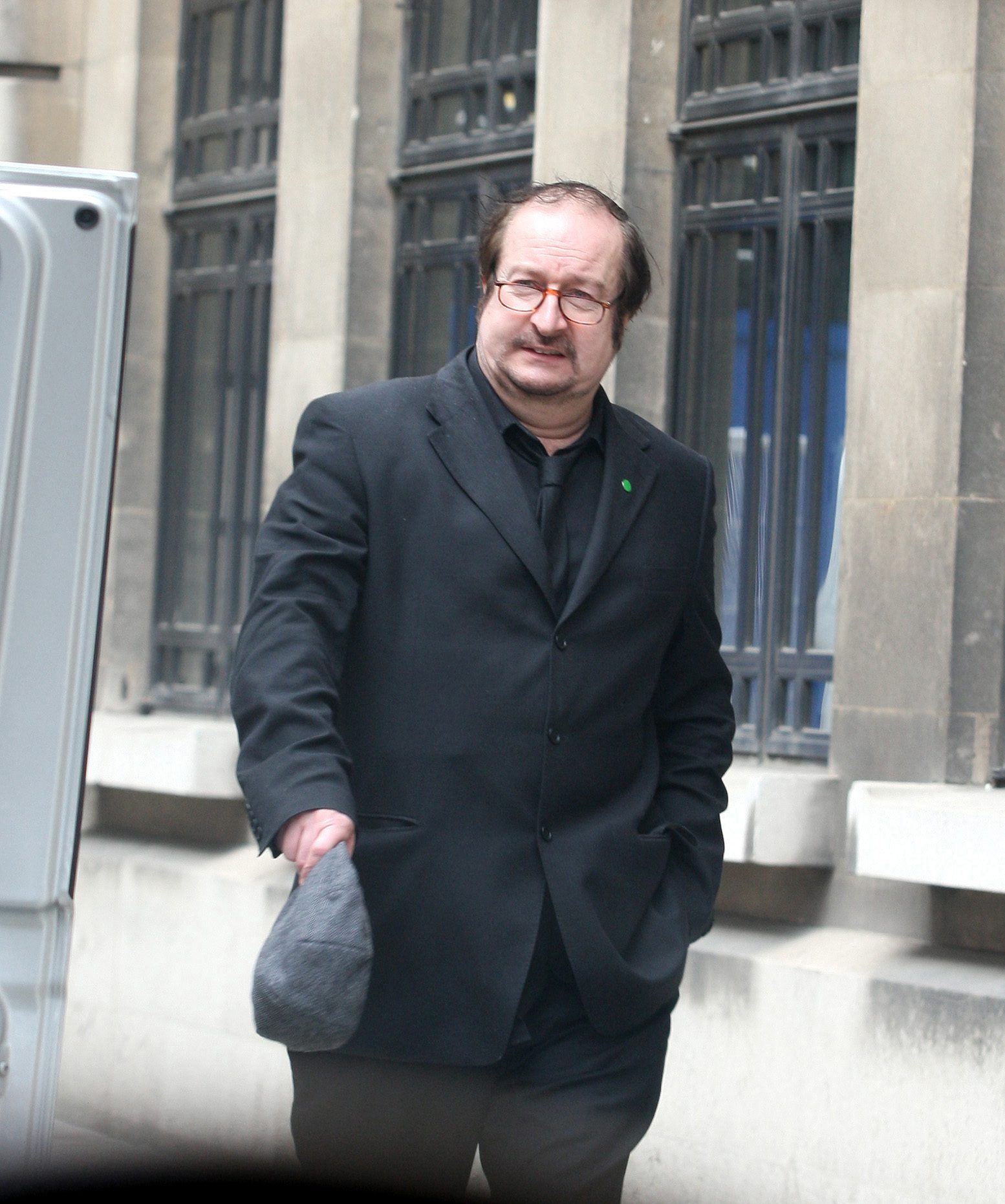 Steve Wright walking down the street in a suit