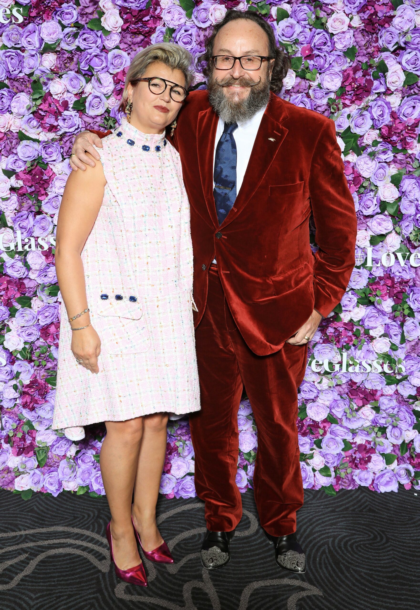 Dave Myers smiling with her arm around wife 