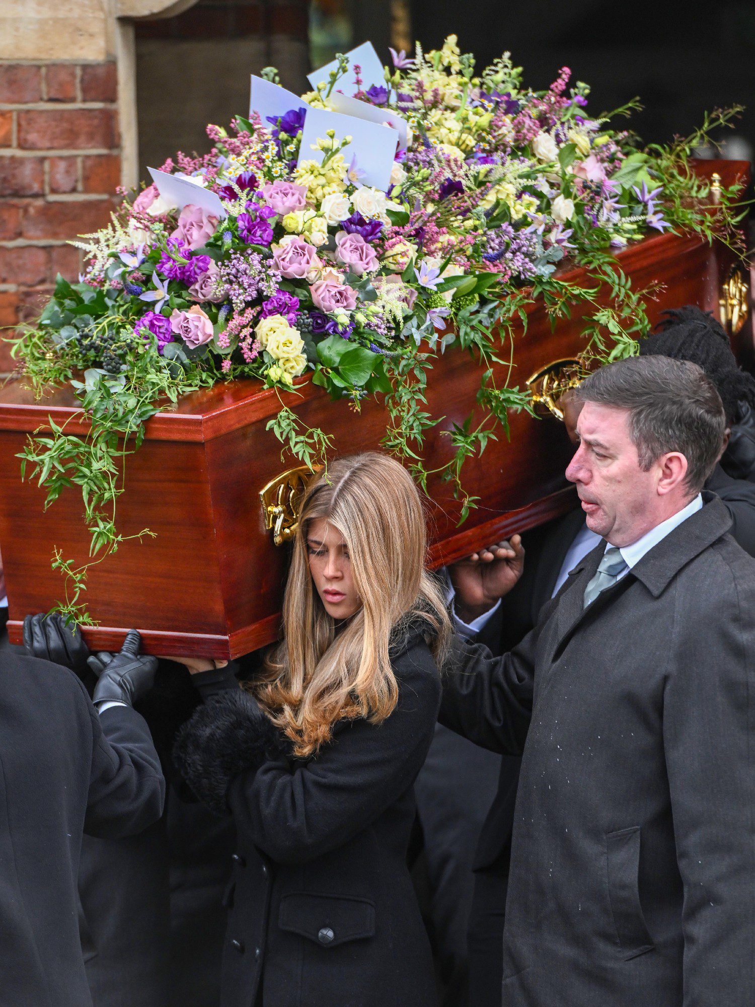 Darcey Draper carrying dad Derek's coffin at funeral