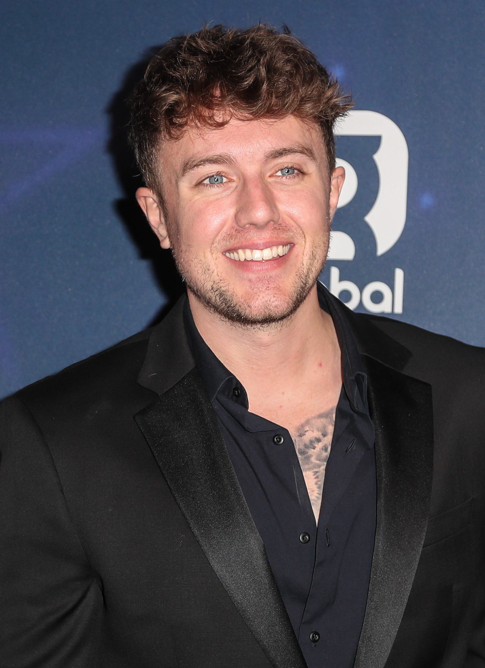 Roman Kemp smiling at Global radio
