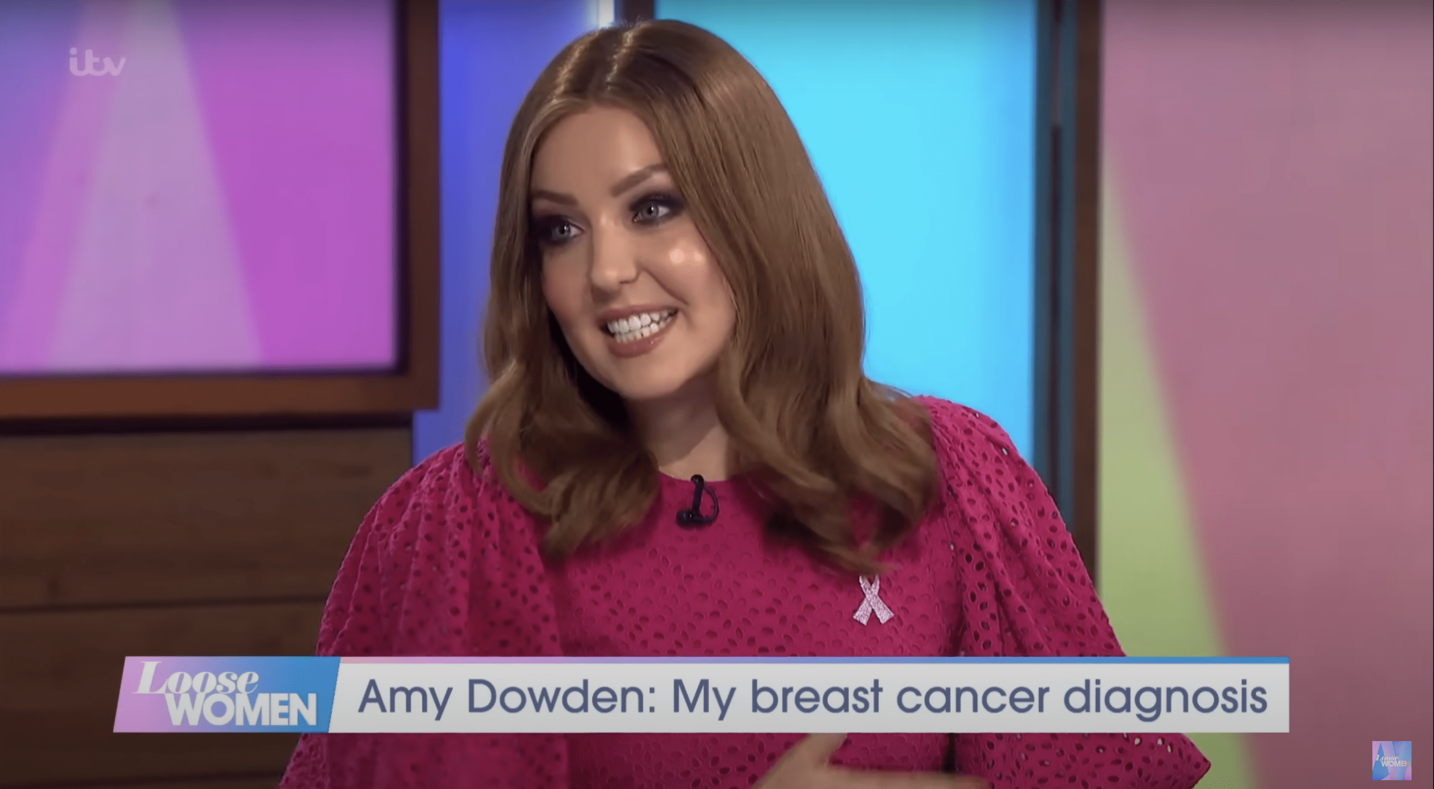 Amy Dowden wearing a brunette wig and pink dress on Loose Women
