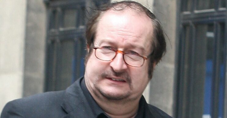 Steve Wright walking down the street in a suit