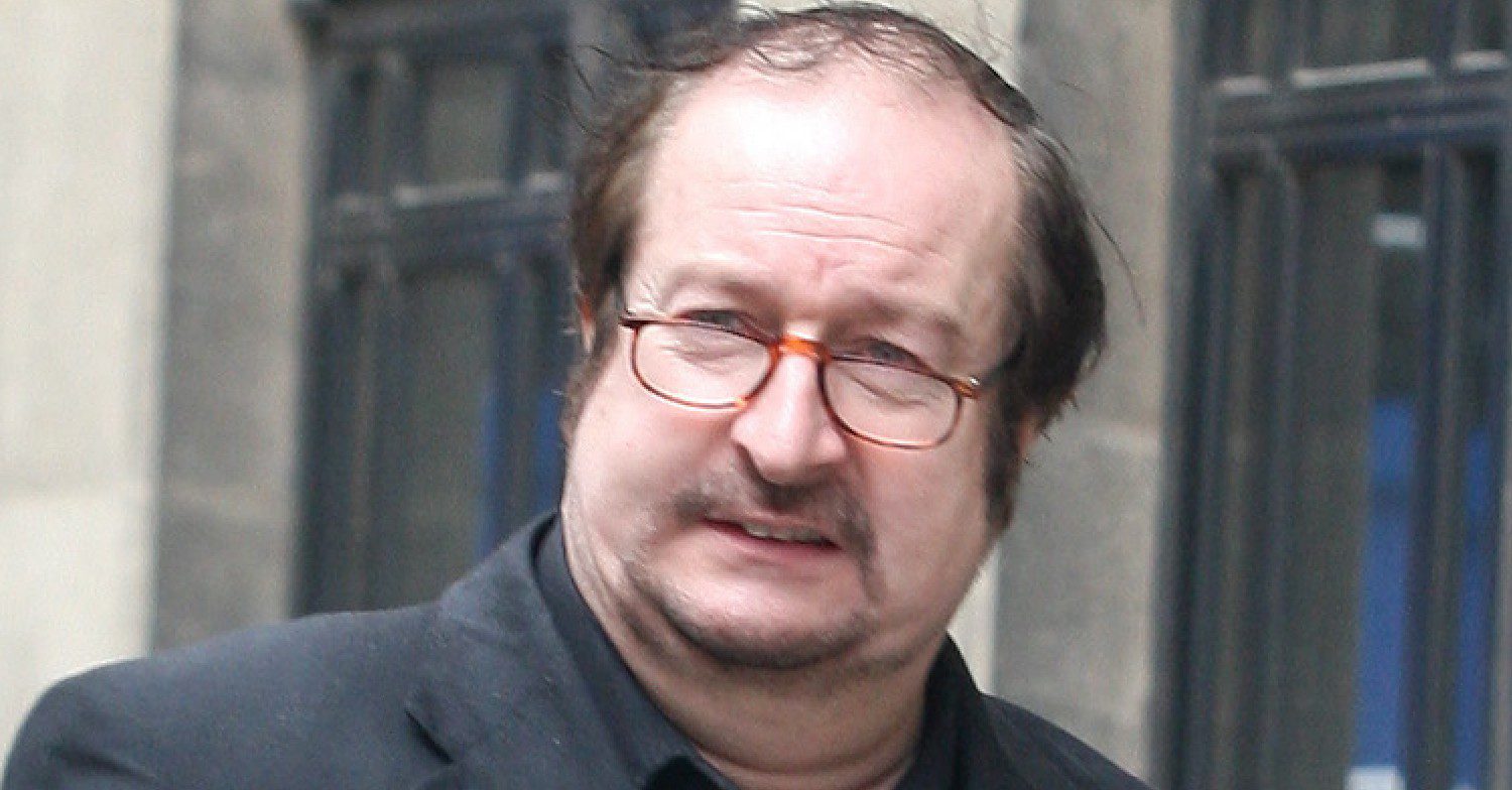 Steve Wright walking down the street in a suit