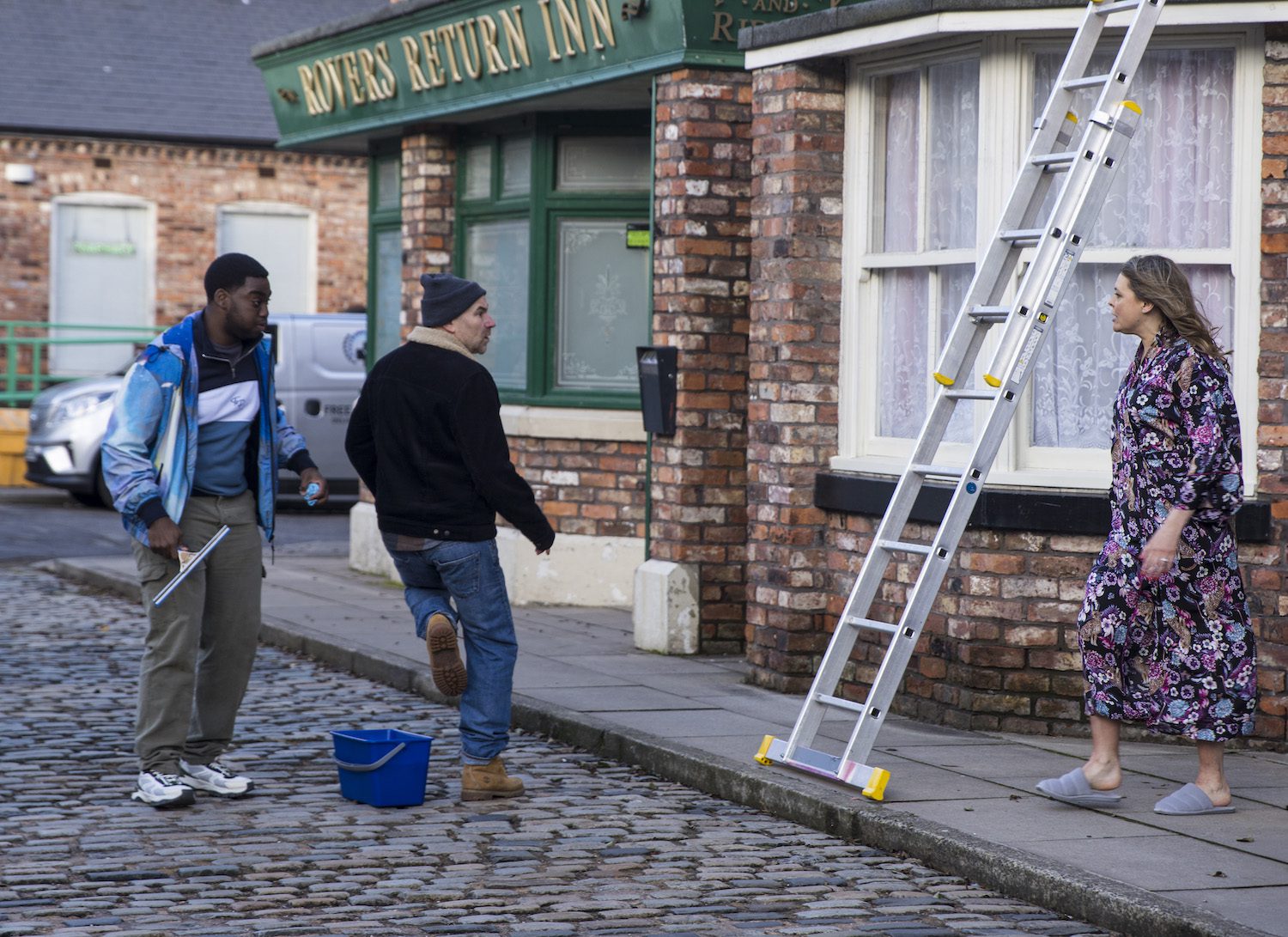 Tracy approaches Gav and Tim in the Street