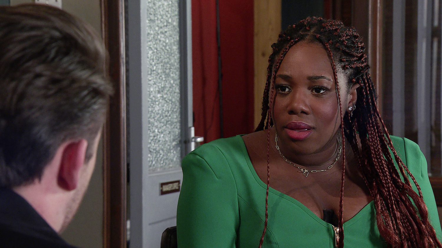 Dee-Dee looks suspicious as she talks to Joel on Corrie