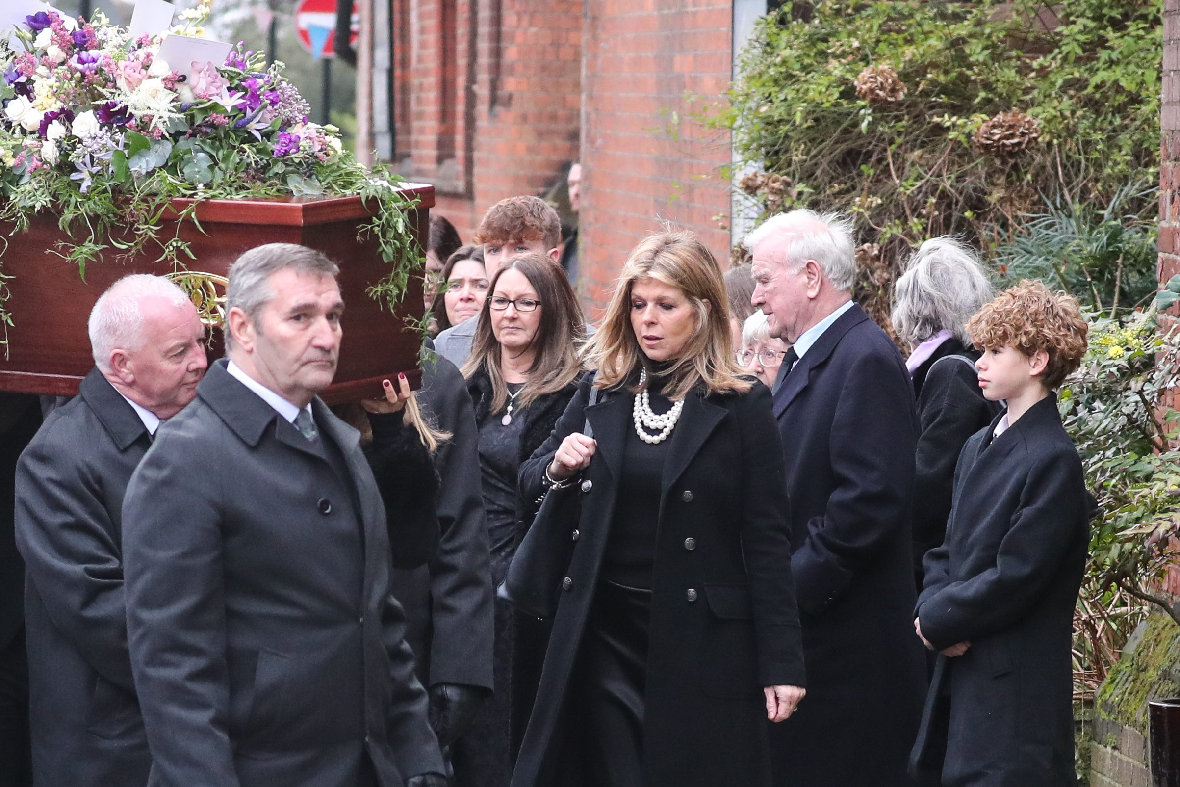 Kate Garraway surrounded by friends as Derek's Coffin is carried inside (John Rainford/Cover Images)