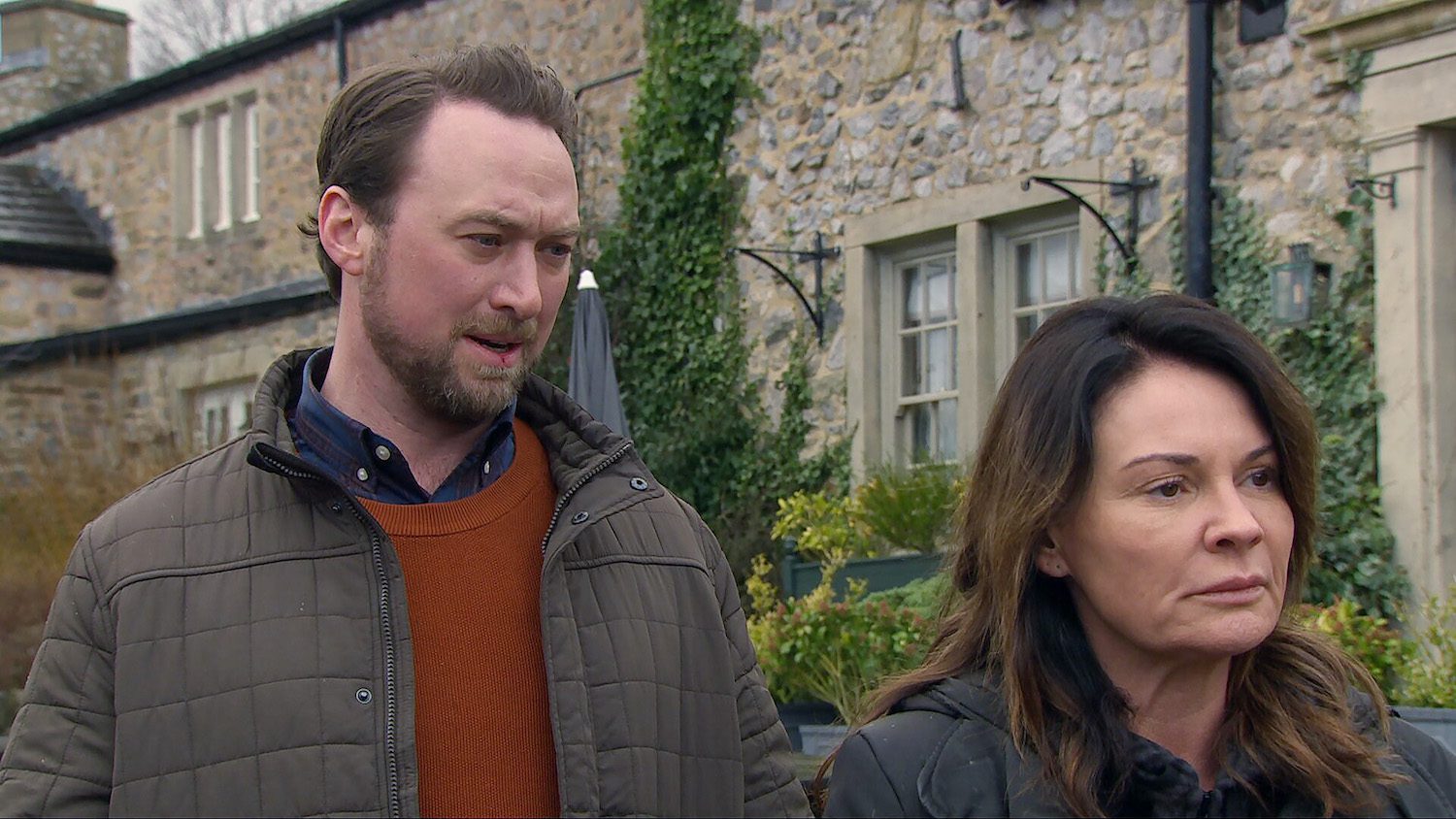 Emmerdale's Chas has her back turned towards Liam outside whilst looking miserable