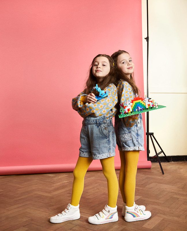 Two little girls posing with Lego models