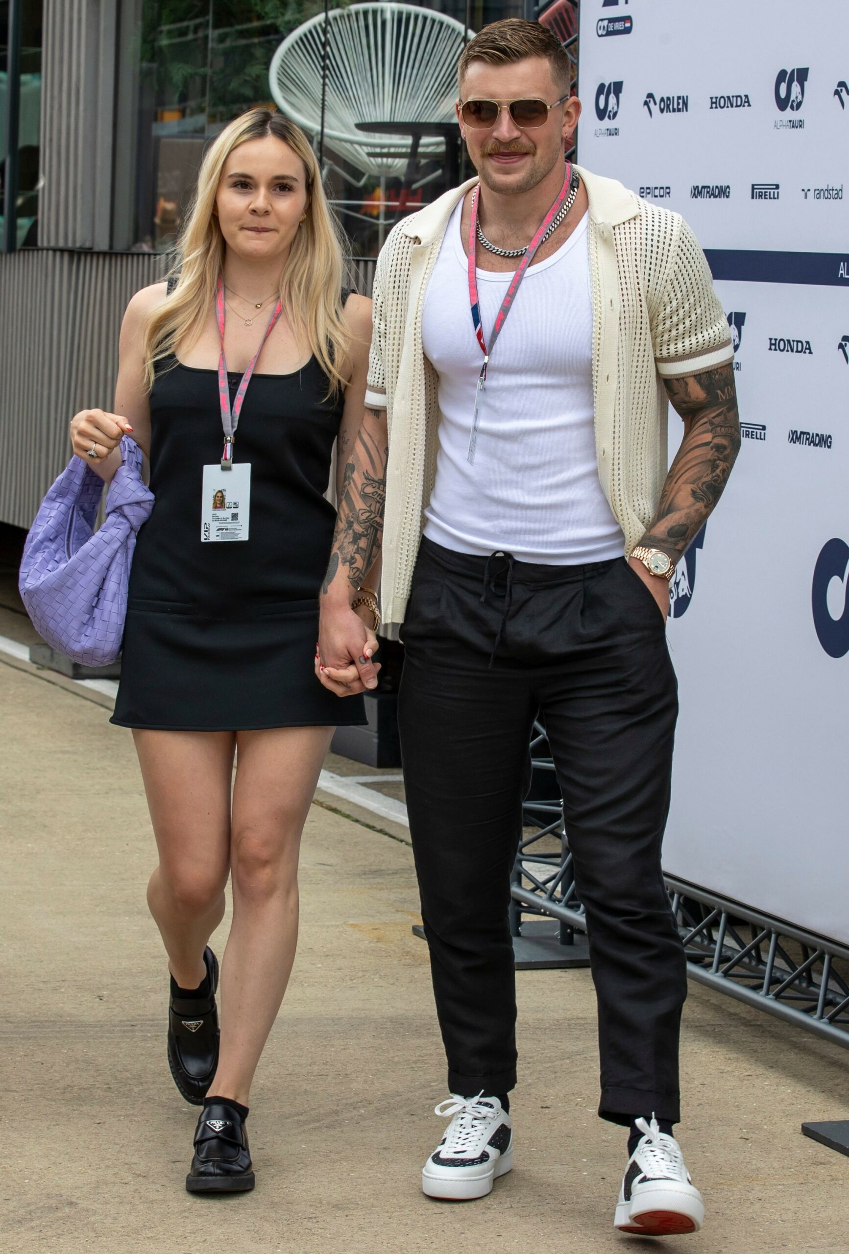 Holly Ramsay and Adam Peaty walking hand in hand at event