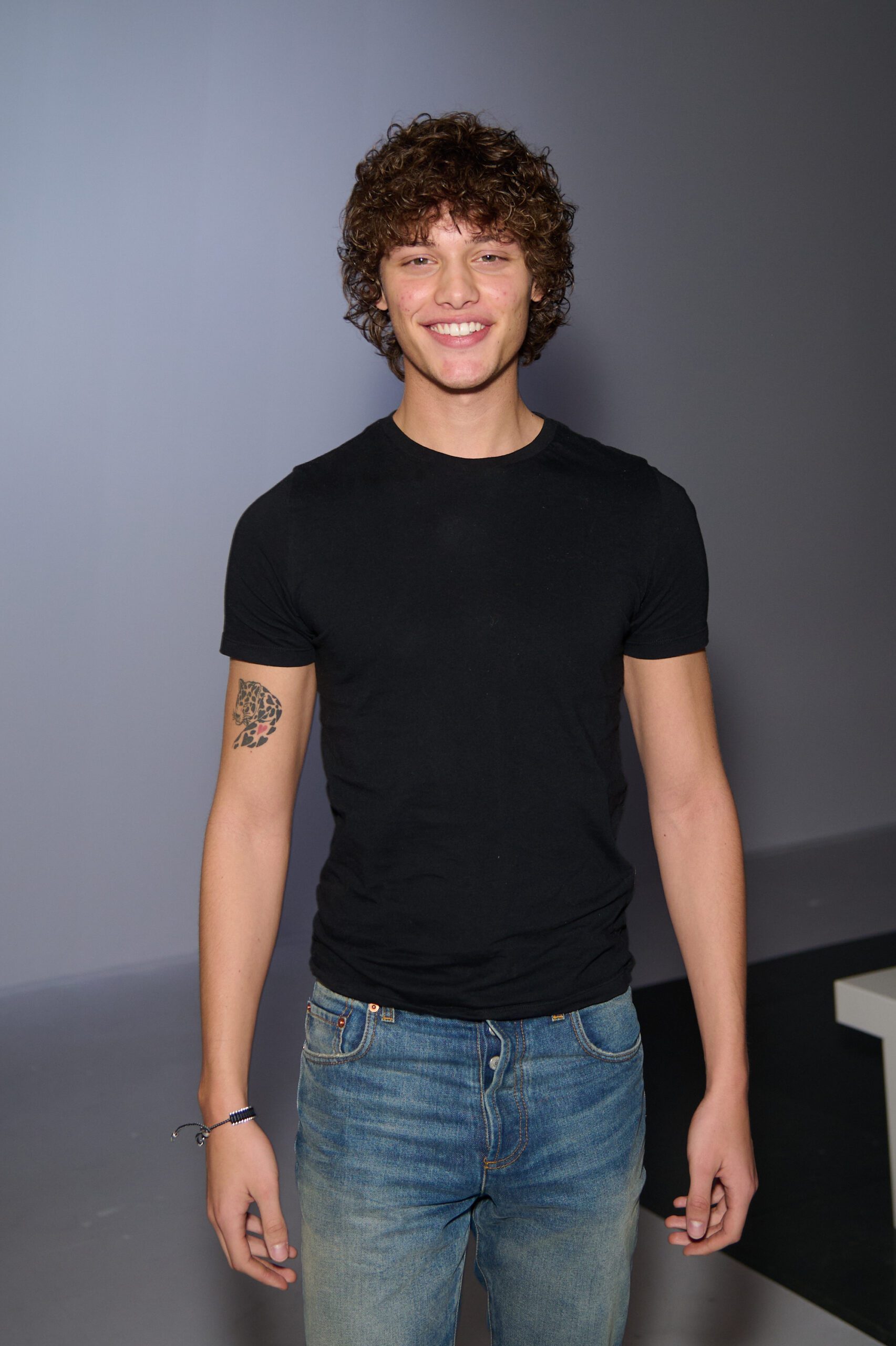 Bobby Brazier smiling in a black T-shirt