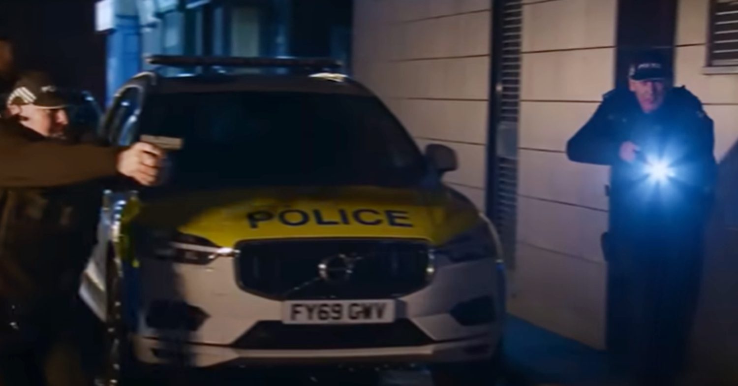 Coronation Street's armed police are with a police car on the Street