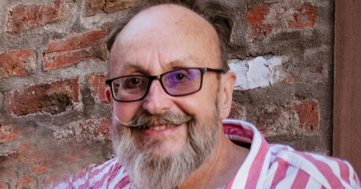 Dave Myers smiling in a striped shirt