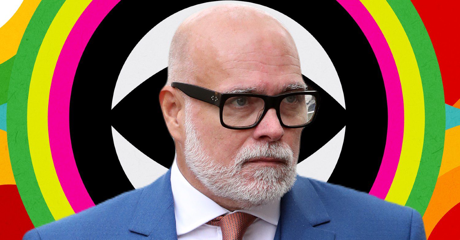 Gary Goldsmith in front of Celebrity Big Brother logo