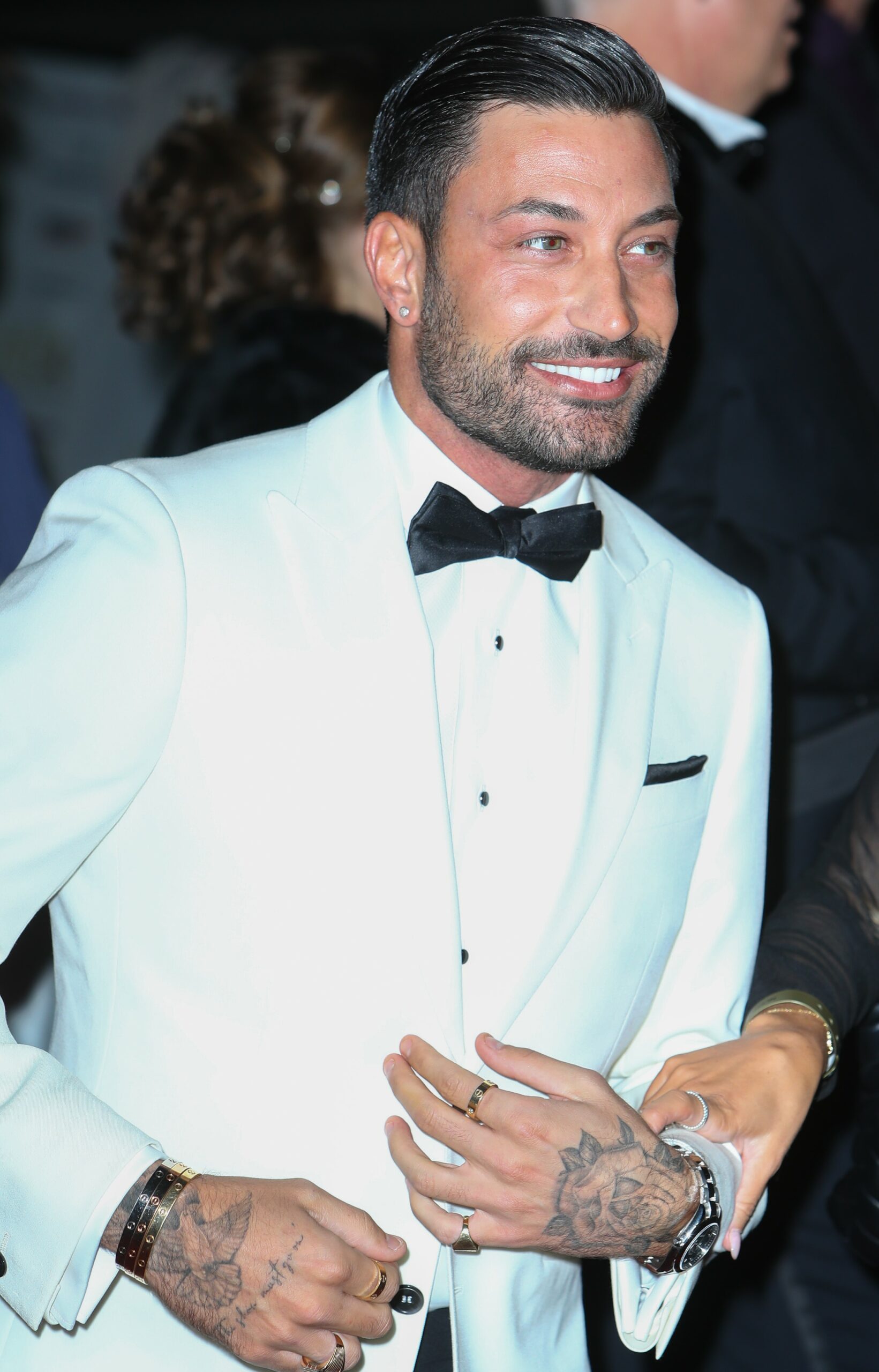 Giovanni Pernice smiling at the NTAs in white suit jacket