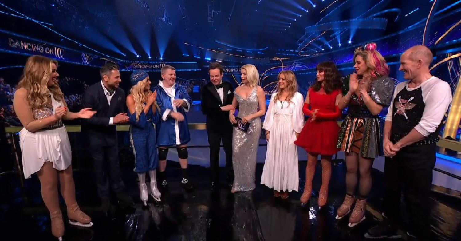 Holly Willoughby in silver dress surrounding by Dancing On Ice stars