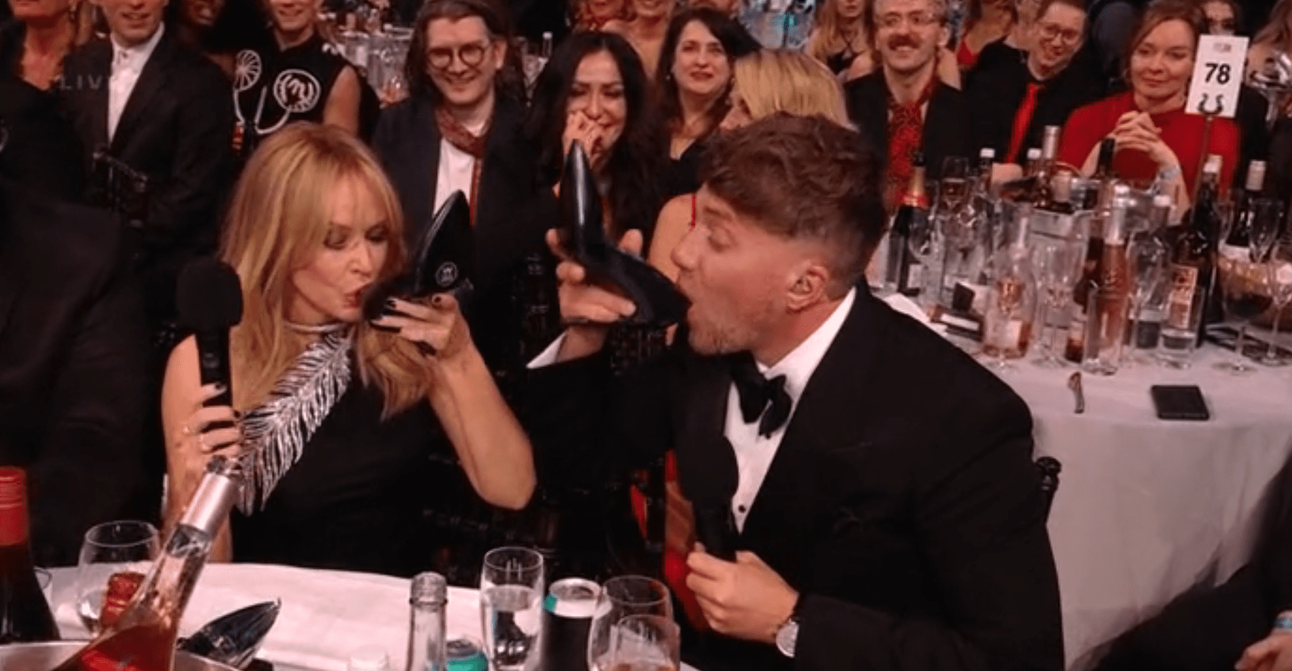 Kylie Minogue and Roman Kemp drink out of shoes