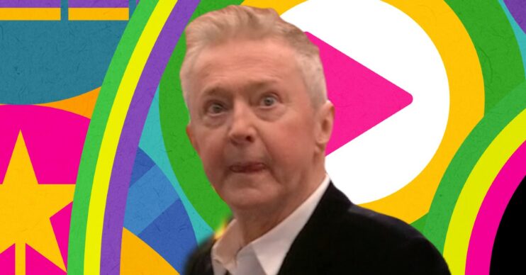 Louis Walsh looking serious in front of Celebrity Big Brother logo