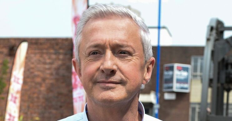 Louis Walsh hands in pockets blue shirt close up comp