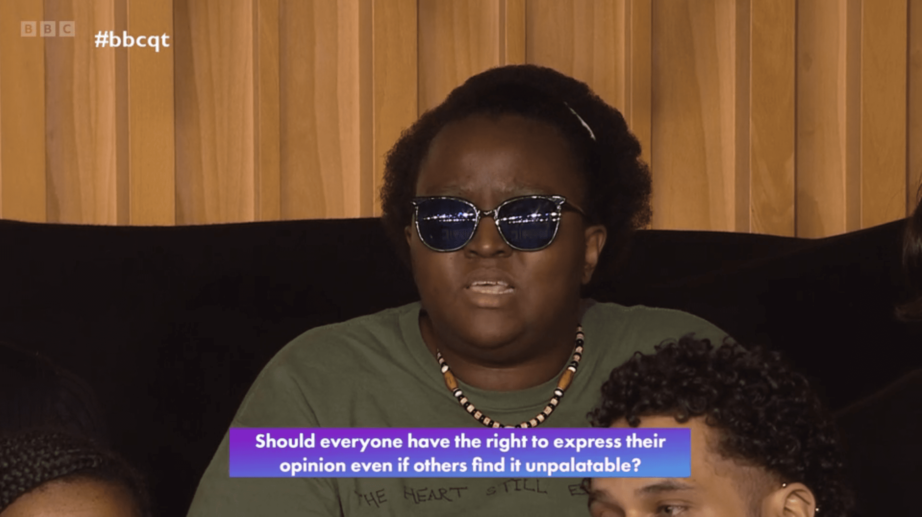 Woman sat in Question Time audience wearing prescription sunglasses for a visual impairment