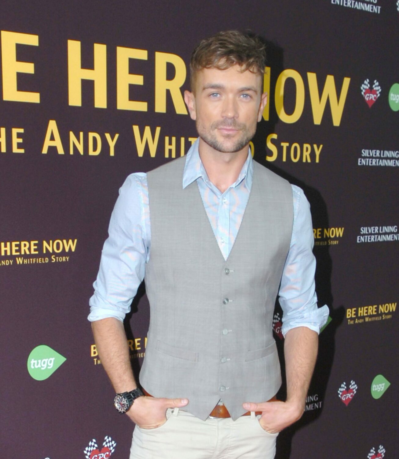Emrhys Cooper on the red carpet smiling