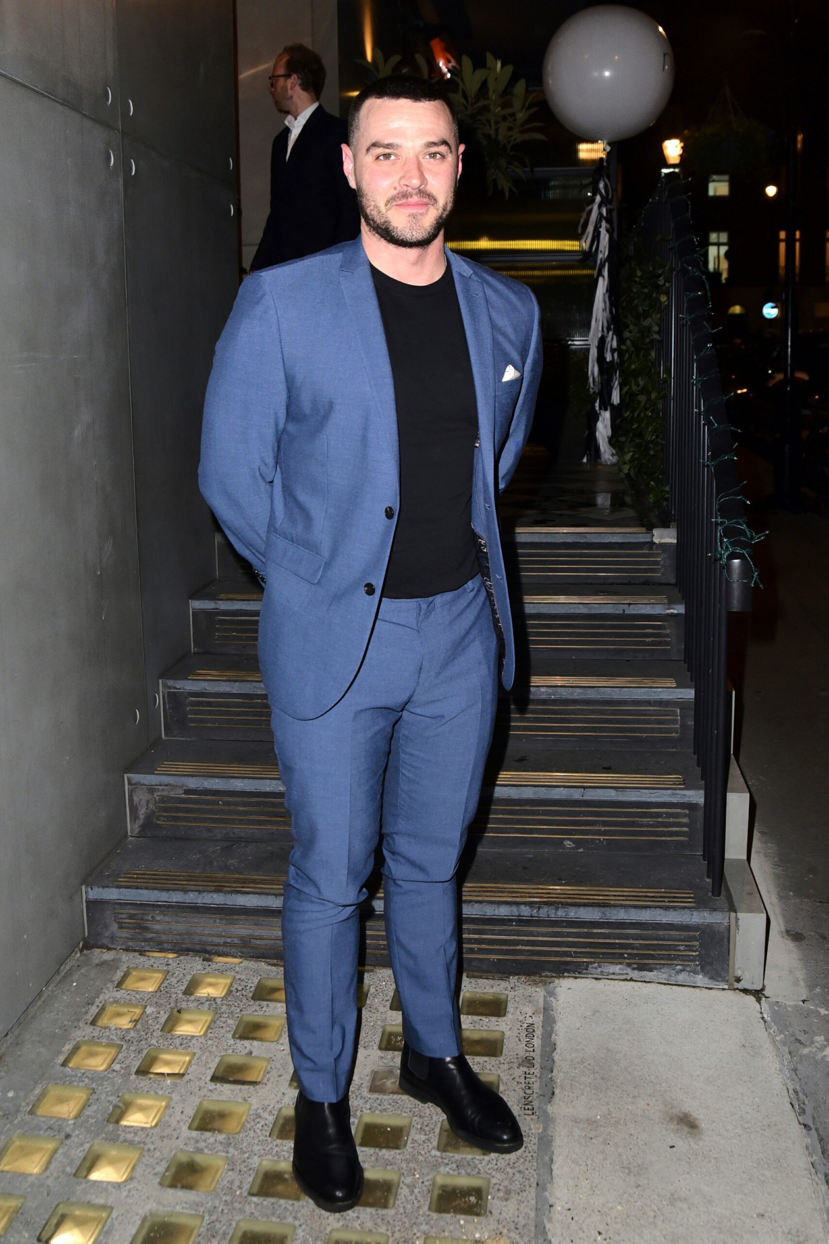Matt Willis posing outsied a restaurant in a blue suit