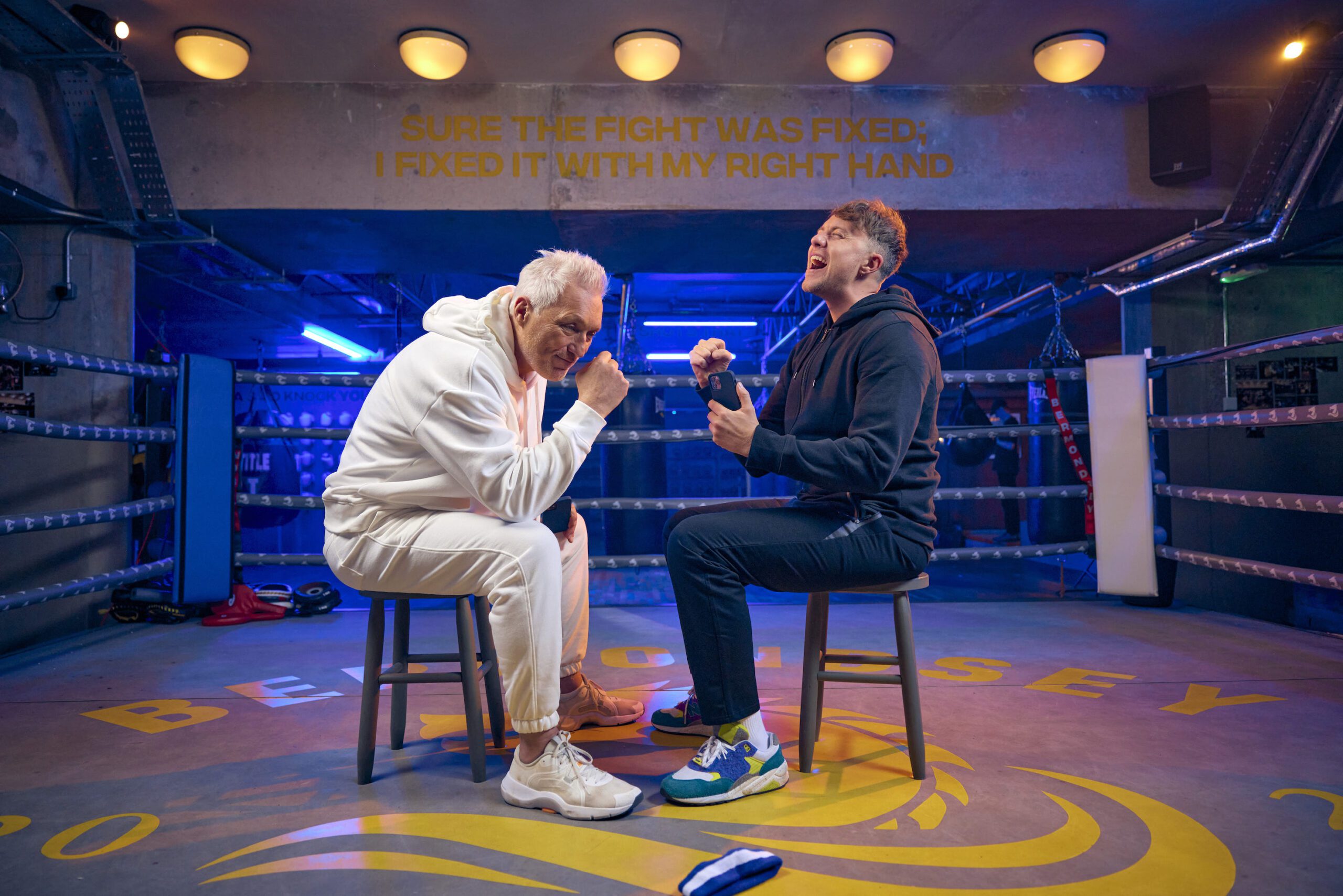 Martin and Roman Kemp sitting in the middle of a boxing ring