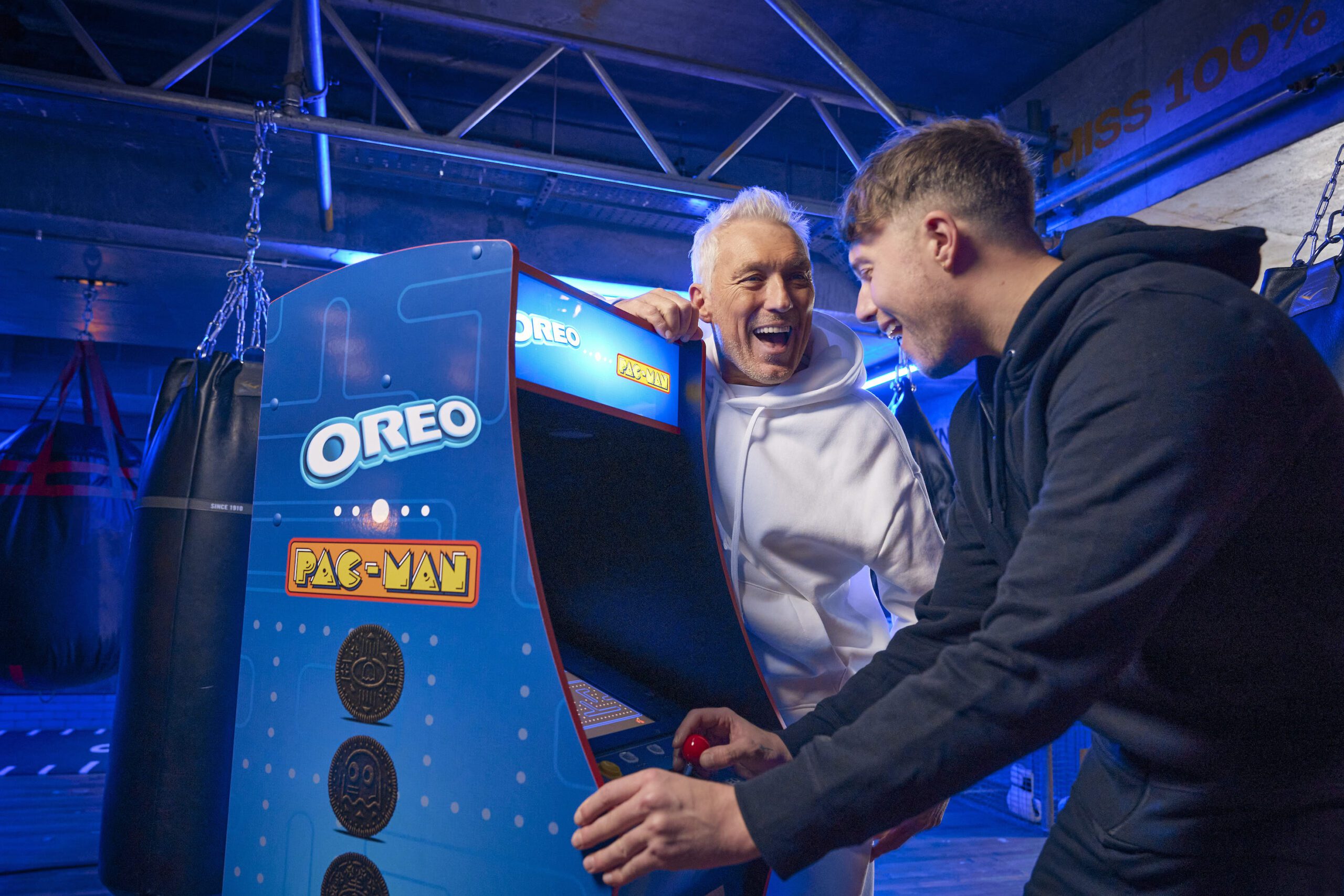 Martin and Roman Kempl playing on a Pacman arcade game