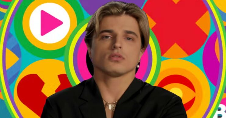 Nikita Kuzmin in front of Celebrity Big Brother logo
