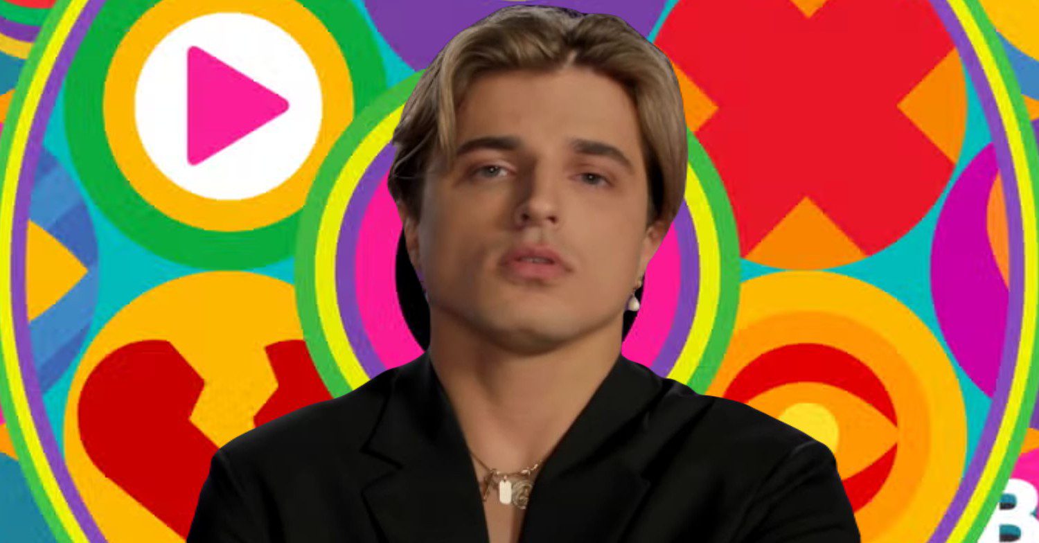 Nikita Kuzmin in front of Celebrity Big Brother logo