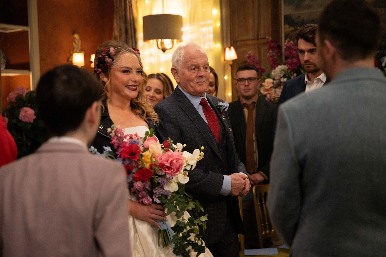 Amy walks down the aisle smiling in Emmerdale