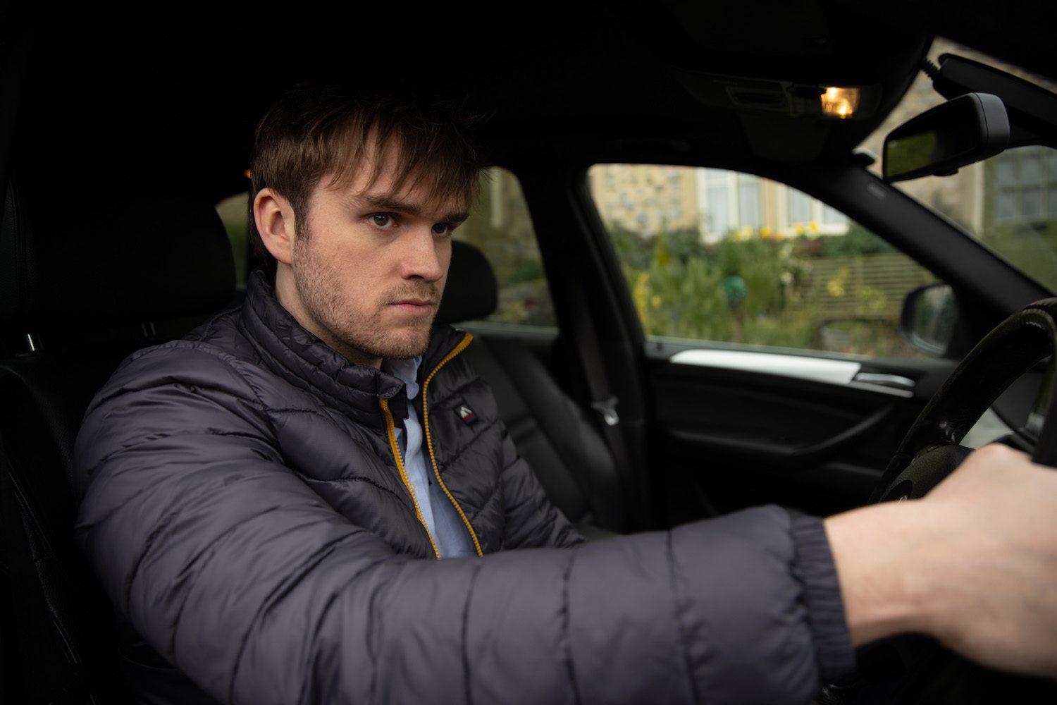 Tom looking angry in his car on Emmerdale
