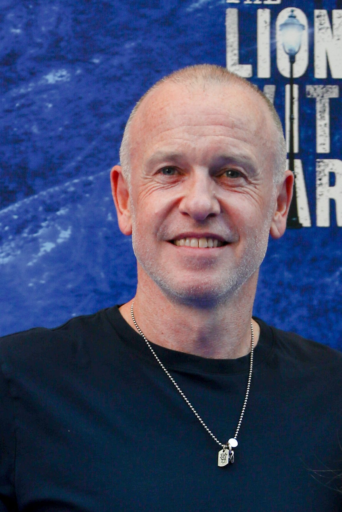 Tim lovejoy smiling at a press event