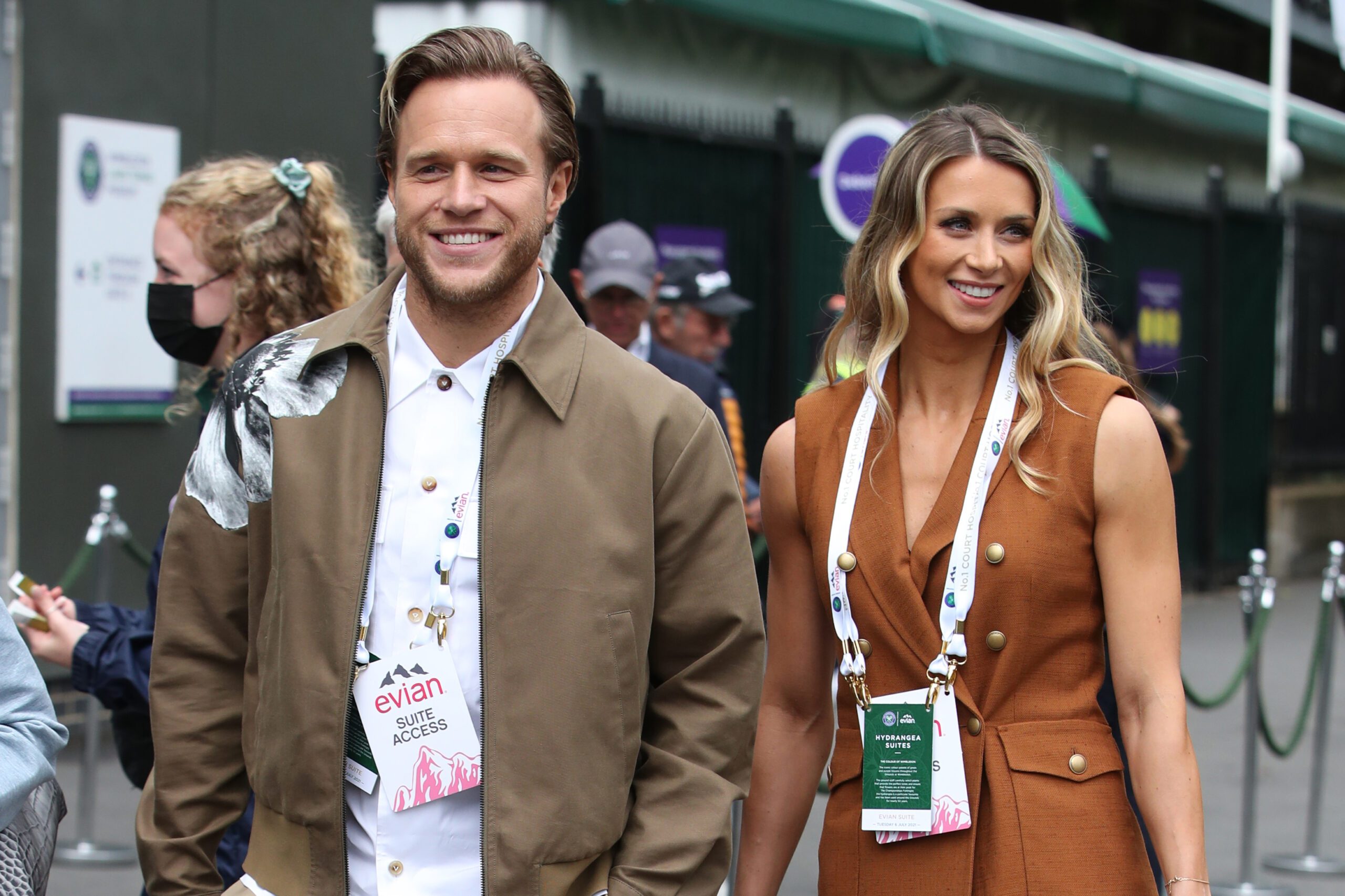 Olly Murs and wife Amelia Tank have just welcomed their first baby, Olly and Amelia holding hands and walking