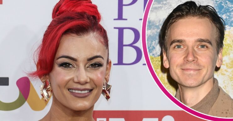 Dianne Buswell smiling and wearing hair up beside cut-out of Joe Sugg on red carpet