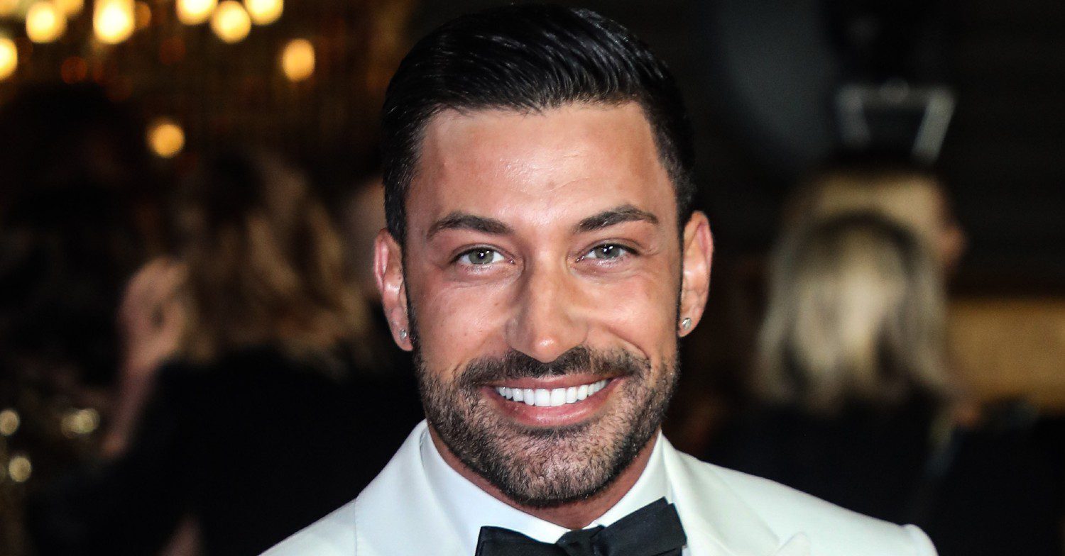 Giovanni Pernice smiling wearing white tuxedo and black bow tie