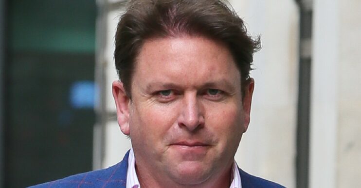 James Martin looking to camera while walking in the street
