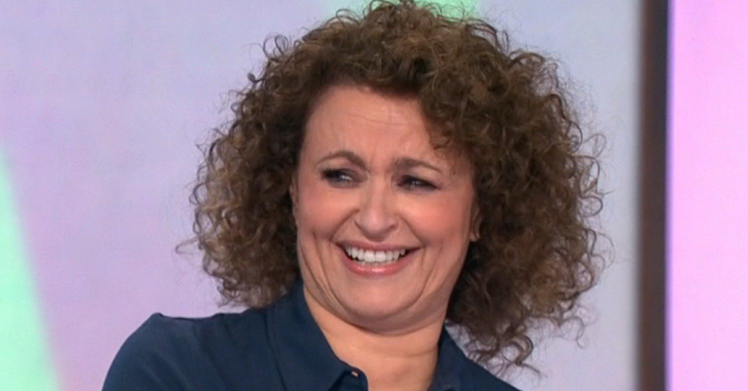 Loose Women star Nadia Sawalha laughing on set of Loose Women wearing blue shirt close-up comp