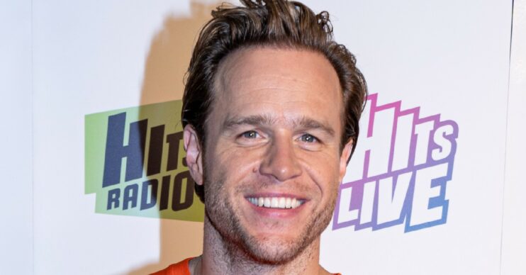 Olly Murs smiling against a white background