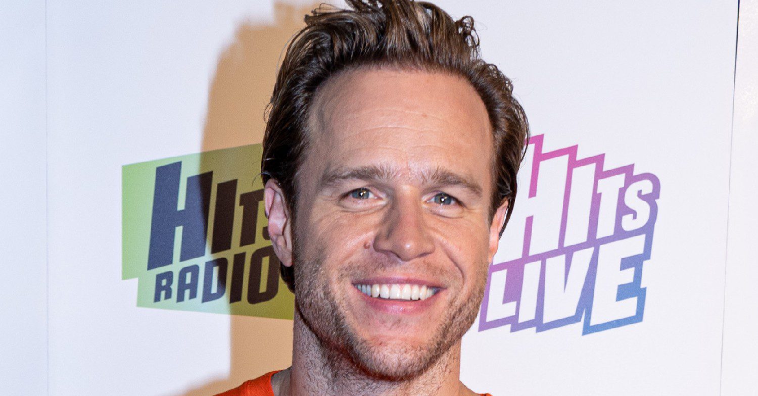 Olly Murs smiling against a white background