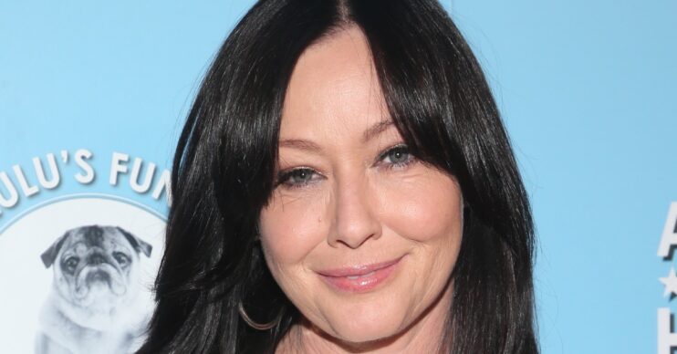 Shannen Doherty smiling wearing white